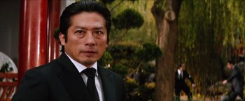 Movie still from “The Wolverine” (2013), directed by James Mangold – A person wearing a suit and tie; Close Up shot, Low angle