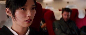 Movie still from “The Wolverine” (2013), directed by James Mangold – A person sitting on a train; Close Up shot, Over the shoulder angle