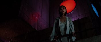Movie still from “The Wolverine” (2013), directed by James Mangold – A woman holding a sword standing in front of a red light; Medium shot, Low angle