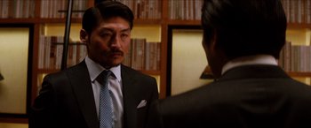 Movie still from “The Wolverine” (2013), directed by James Mangold – A man wearing a suit and tie talking to another man in a suit; Close Up shot, Over the shoulder angle