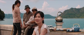 Movie still from “The Wolverine” (2013), directed by James Mangold – A woman sitting next to a man and a teapot; Medium shot, Over the shoulder angle