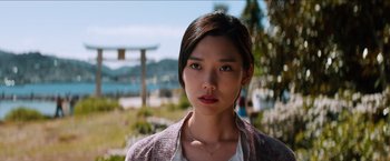 Movie still from “The Wolverine” (2013), directed by James Mangold – A young woman with brown hair wearing a white shirt and a pink jacket; Close Up shot, Low angle