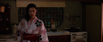 Movie still from “The Wolverine” (2013), directed by James Mangold – A woman in a kimono standing in front of a window; Medium shot, Over the shoulder angle
