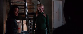 Movie still from “The Wolverine” (2013), directed by James Mangold – A woman in a green shirt and leather pants; Medium shot, Over the shoulder angle