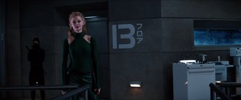 Movie still from “The Wolverine” (2013), directed by James Mangold – A woman standing in front of a building with the number 1 3 on it; Medium shot, Low angle