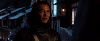 Movie still from “The Wolverine” (2013), directed by James Mangold – A man wearing a black leather jacket and standing next to a window; Close Up shot, Low angle