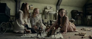 Movie still from “The Woman in Black” (2012), directed by James Watkins – A group of girls sitting on the floor playing a game; Wide shot, Low angle