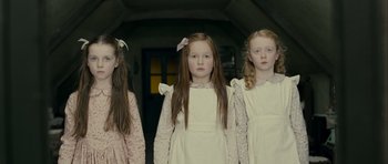 Movie still from “The Woman in Black” (2012), directed by James Watkins – A group of three young girls standing next to each other; Medium shot, Low angle