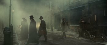 Movie still from “The Woman in Black” (2012), directed by James Watkins – A group of men walking down a street; Wide shot, Low angle