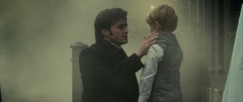 Movie still from “The Woman in Black” (2012), directed by James Watkins – A man is adjusting a young boy's collar; Close Up shot, Over the shoulder angle