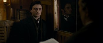Movie still from “The Woman in Black” (2012), directed by James Watkins – A man in a suit standing in front of a mirror; Close Up shot, Over the shoulder angle