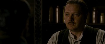 Movie still from “The Woman in Black” (2012), directed by James Watkins – A person wearing a suit and tie; Close Up shot, Over the shoulder angle