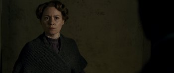 Movie still from “The Woman in Black” (2012), directed by James Watkins – A woman in a dark room wearing a sweater; Close Up shot, Low angle