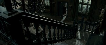 Movie still from “The Woman in Black” (2012), directed by James Watkins – A staircase with a railing in the middle of the floor; Wide shot, High angle