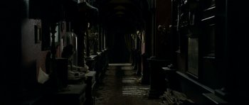 Movie still from “The Woman in Black” (2012), directed by James Watkins – A dark room with many statues in it; Wide shot, High angle