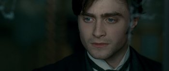 Movie still from “The Woman in Black” (2012), directed by James Watkins – A person wearing a suit and tie; Close Up shot, High angle