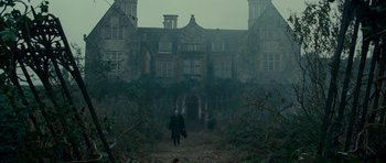 Movie still from “The Woman in Black” (2012), directed by James Watkins – A man walking in front of an old mansion; Extreme Wide shot, Low angle
