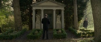 Movie still from “The Woman in Black” (2012), directed by James Watkins – A man standing in front of a stone building; Wide shot, Low angle