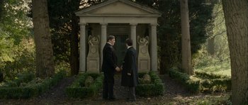 Movie still from “The Woman in Black” (2012), directed by James Watkins – Two men holding hands in front of a building; Wide shot, High angle