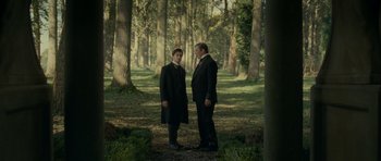 Movie still from “The Woman in Black” (2012), directed by James Watkins – Two men standing in the middle of a forest; Wide shot, Over the shoulder angle