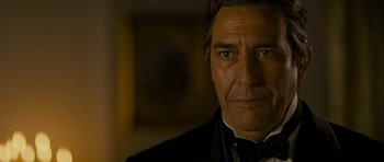 Movie still from “The Woman in Black” (2012), directed by James Watkins – A person wearing a suit and tie; Close Up shot, Over the shoulder angle