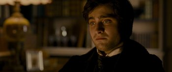 Movie still from “The Woman in Black” (2012), directed by James Watkins – A person wearing a suit and tie; Close Up shot, Over the shoulder angle