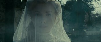 Movie still from “The Woman in Black” (2012), directed by James Watkins – A young woman wearing a veil looking at the camera; Close Up shot, Over the shoulder angle
