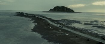 Movie still from “The Woman in Black” (2012), directed by James Watkins – A couple of people are walking on the beach; Extreme Wide shot, High angle