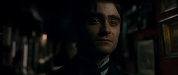 Movie still from “The Woman in Black” (2012), directed by James Watkins – A person wearing a suit and tie; Close Up shot, High angle