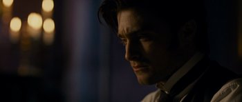 Movie still from “The Woman in Black” (2012), directed by James Watkins – A person wearing a suit and tie; Close Up shot, Over the shoulder angle