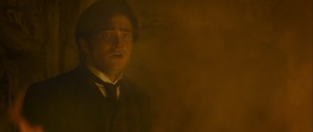 Movie still from “The Woman in Black” (2012), directed by James Watkins – A man in a suit and tie looking at the camera; Medium shot, Low angle