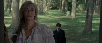 Movie still from “The Woman in Black” (2012), directed by James Watkins – A woman and a man are walking in the woods; Medium shot, Over the shoulder angle