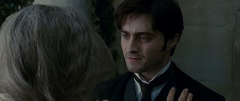 Movie still from “The Woman in Black” (2012), directed by James Watkins – A person wearing a suit and a tie; Close Up shot, Over the shoulder angle