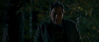 Movie still from “The Woman in Black” (2012), directed by James Watkins – An older man in a dark forest looking at the camera; Close Up shot, Low angle