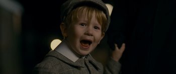 Movie still from “The Woman in Black” (2012), directed by James Watkins – A young boy wearing a hat and a jacket; Close Up shot, High angle
