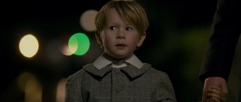 Movie still from “The Woman in Black” (2012), directed by James Watkins – A young boy wearing a suit and tie; Close Up shot, High angle