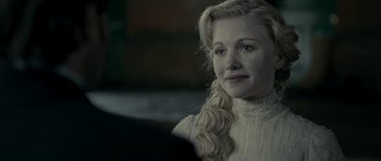 Movie still from “The Woman in Black” (2012), directed by James Watkins – A woman with long blonde hair sitting in a room; Close Up shot, Over the shoulder angle