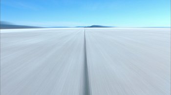 Movie still from “The World's Fastest Indian” (2005), directed by Roger Donaldson – A view of a road from a car on the side of the road; Extreme Wide shot, Low angle