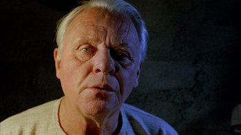 Movie still from “The World's Fastest Indian” (2005), directed by Roger Donaldson – An older man with white hair looking at the camera; Close Up shot, Low angle