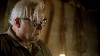 Movie still from “The World's Fastest Indian” (2005), directed by Roger Donaldson – An older man with white hair wearing glasses; Close Up shot, Over the shoulder angle