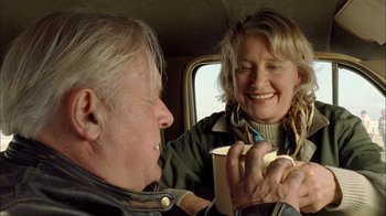 Movie still from “The World's Fastest Indian” (2005), directed by Roger Donaldson – An older man and a younger woman in a car; Close Up shot, Over the shoulder angle