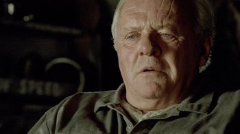 Movie still from “The World's Fastest Indian” (2005), directed by Roger Donaldson – An older man with a goatee looking at the camera; Close Up shot, Low angle