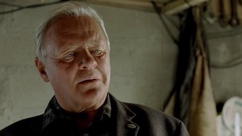 Movie still from “The World's Fastest Indian” (2005), directed by Roger Donaldson – An older man with white hair looking at the camera; Close Up shot, Over the shoulder angle