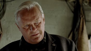 Movie still from “The World's Fastest Indian” (2005), directed by Roger Donaldson – An older man in a black jacket looking at the camera; Close Up shot, Low angle