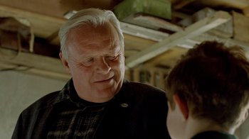 Movie still from “The World's Fastest Indian” (2005), directed by Roger Donaldson – An older man is talking to a younger man; Close Up shot, Over the shoulder angle
