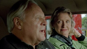 Movie still from “The World's Fastest Indian” (2005), directed by Roger Donaldson – An older man and a younger woman sitting in the back of a car; Close Up shot, Over the shoulder angle