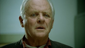 Movie still from “The World's Fastest Indian” (2005), directed by Roger Donaldson – An older man with a white beard and a red plaid shirt; Close Up shot, Low angle