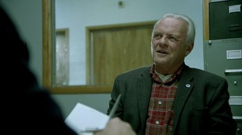 Movie still from “The World's Fastest Indian” (2005), directed by Roger Donaldson – An older man is holding a pen and paper; Close Up shot, Over the shoulder angle