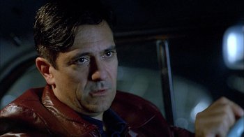 Movie still from “The World's Fastest Indian” (2005), directed by Roger Donaldson – A person wearing a red leather jacket; Close Up shot, Over the shoulder angle