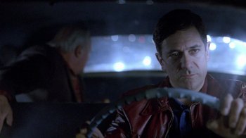 Movie still from “The World's Fastest Indian” (2005), directed by Roger Donaldson – A man driving a car at night in the dark; Close Up shot, Low angle